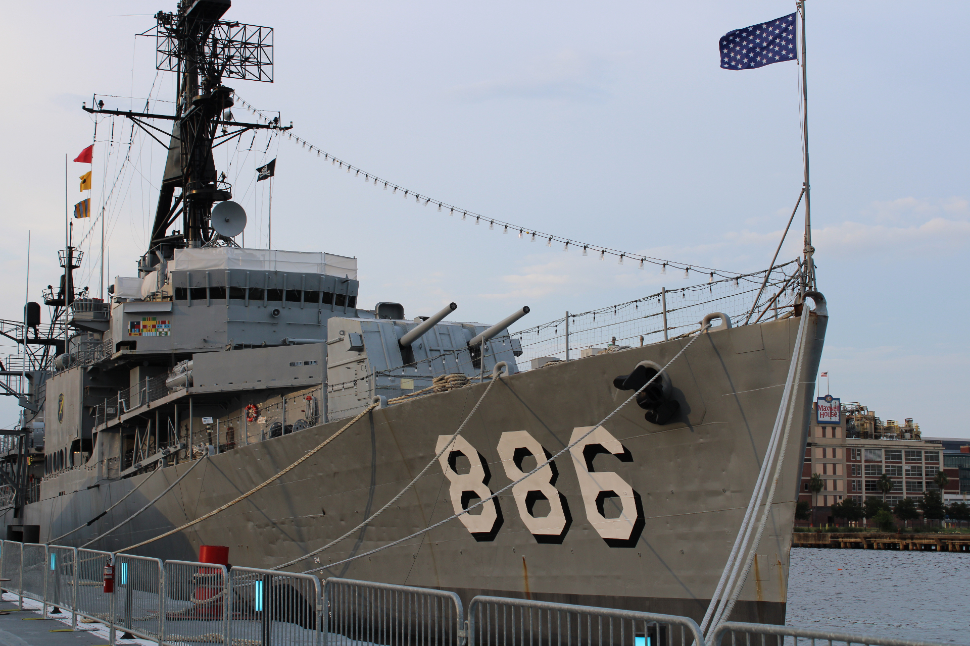 USS Orleck docked along the Jacksonville riverfront with the ship number 886 and American flag visible