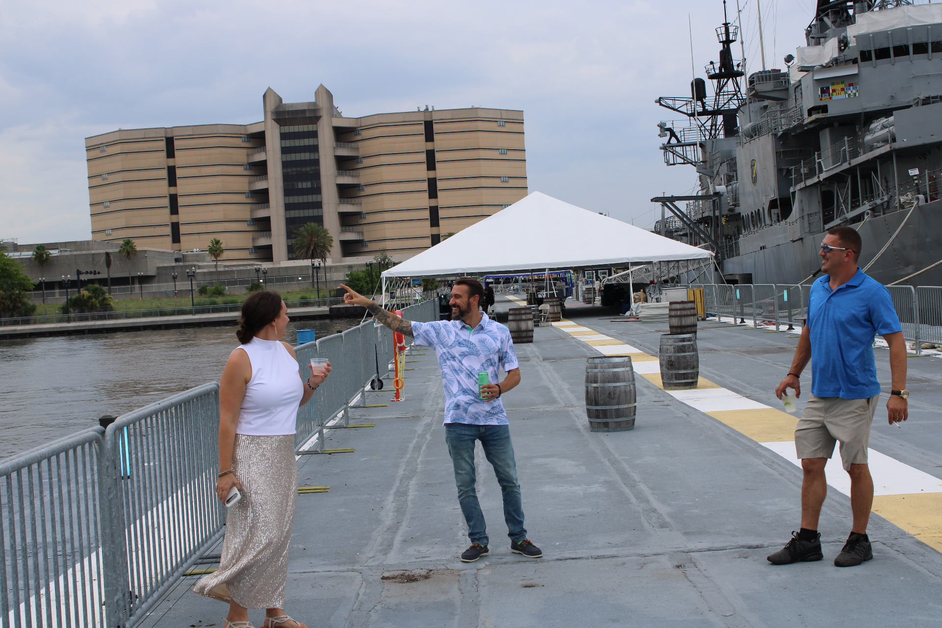 Guests chatting on the pier beside the USS Orleck during the Life Well Balanced dinner