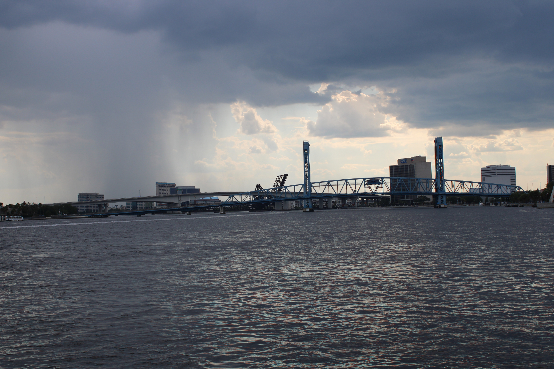 Main Street Bridge over the St. Johns River with rain showers in the distance over downtown Jacksonville